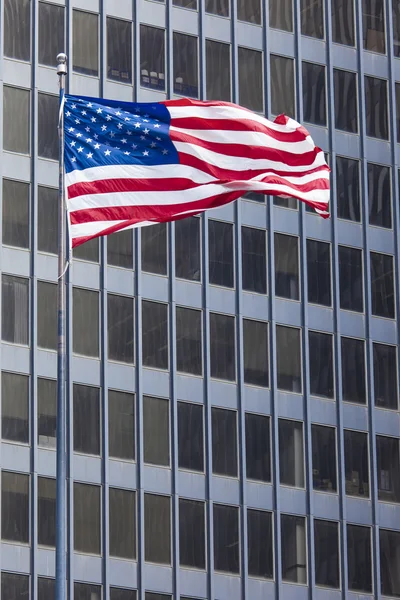 US american symbol flag over blue modern city buildings — Stock Photo, Image