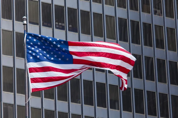 US american symbol flag over blue modern city buildings — Stock Photo, Image