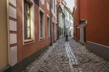 Decorative water column in narrow medieval street of old Riga ci