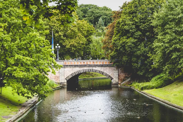 Park ve turist tekne yelken ağaçların arasından güneş ışığı — Stok fotoğraf