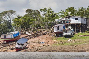 MANAUS, BRAZIL, OCTOBER 17: Typical wooden wooden houses on Rio  clipart