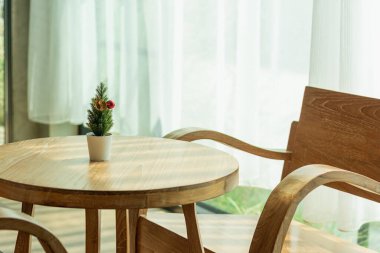 Brown antique teak table set in the interior of a coffee shop.