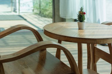 Brown antique teak table set in the interior of a coffee shop.