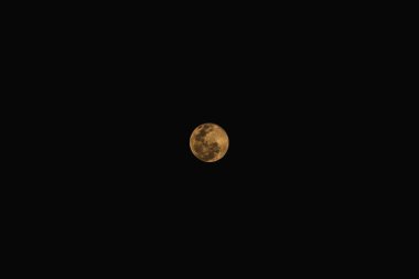 The full moon isolated on black space background.