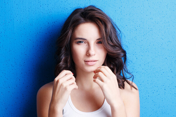 Portrait attractive woman   on blue background.