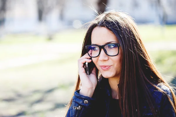 Portrait of a beautiful adult sensual woman in glasses with phon — Stock Photo, Image