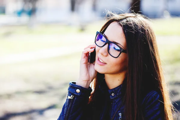 Portrait of a beautiful adult sensual woman in glasses with phon — Stock Photo, Image