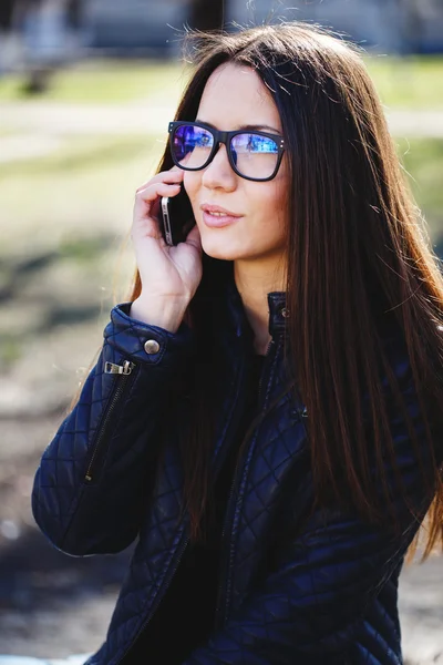 Portrait of a beautiful adult sensual woman in glasses with phon — Stock Photo, Image