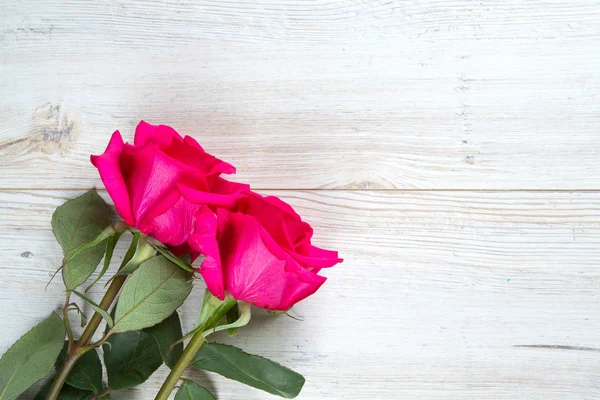 Beautiful roses on wooden table — Stock Photo, Image
