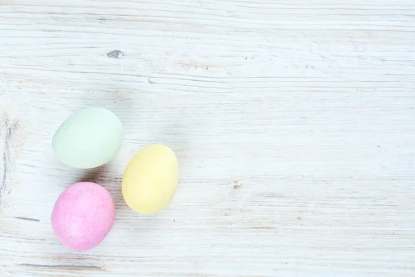 Marcipan eggs on white wooden surface — Stock Photo, Image