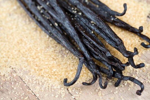 Vanilla pods and brown cane sugar — Stock Photo, Image