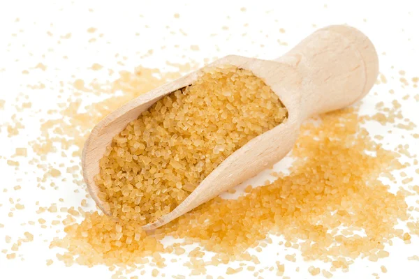Brown cane sugar in a wooden spoon — Stock Photo, Image