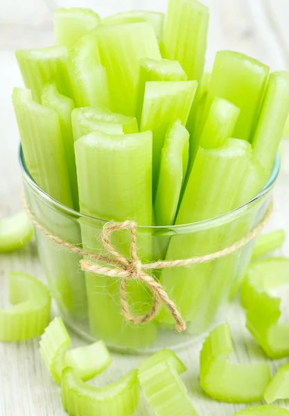 Cut celery on wooden table — Stock Photo, Image