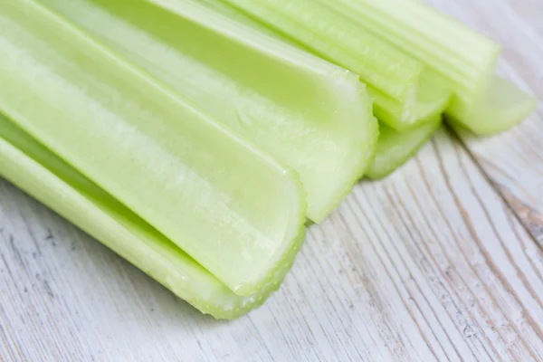 fresh celery sticks on wooden table