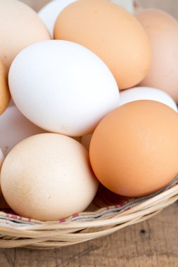 ahşap masa üzerinde bir sepet içinde çiftlik yumurta