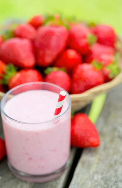 Strawberry milk shake on wooden garden table — Stock Photo, Image
