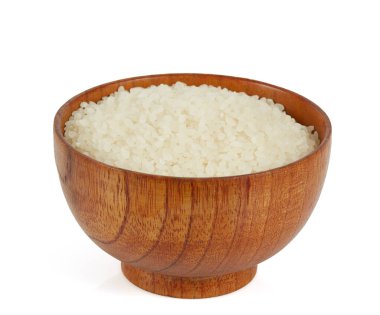 Tahta bir kasede yuvarlak pirinç, beyaz arka planda izole edilmiş.