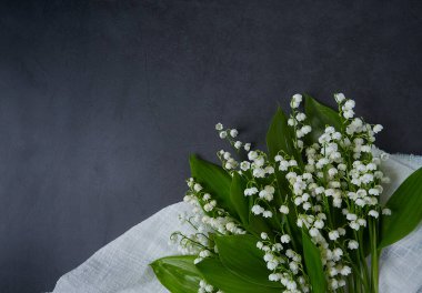 Karanlık yüzeyde bir buket zambak.