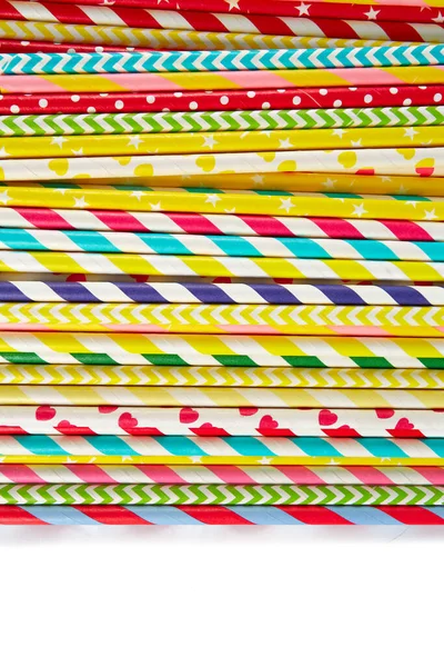 multicolored paper straws on white background