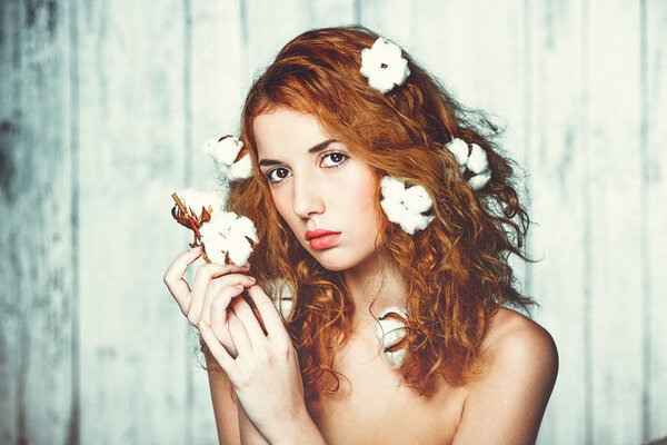 Beautiful girl with cotton plant