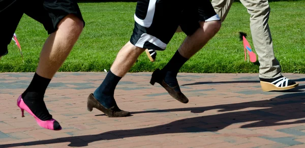 Runners on heels during charity run — Stock Photo, Image