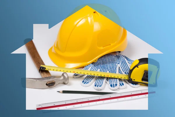 Construction concept - builder's work tools in blue house — Stock Photo, Image