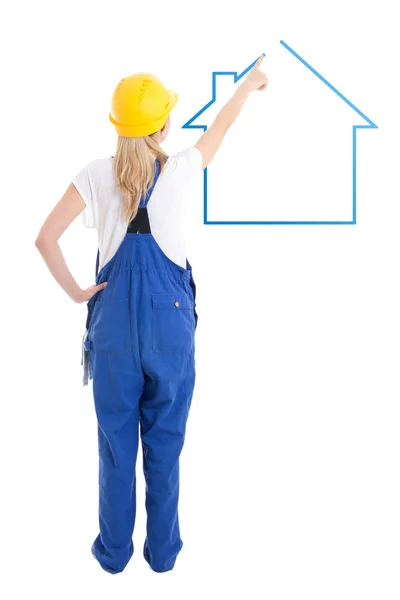 Achteraanzicht van de vrouw in bouwer uniform tekening huis geïsoleerd op — Stockfoto