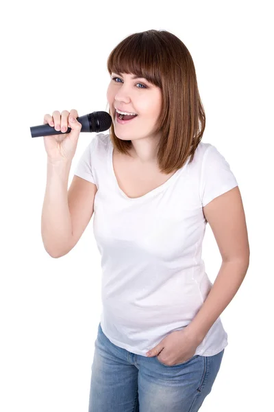 Young beautiful woman singing with microphone isolated on white — Stock Photo, Image