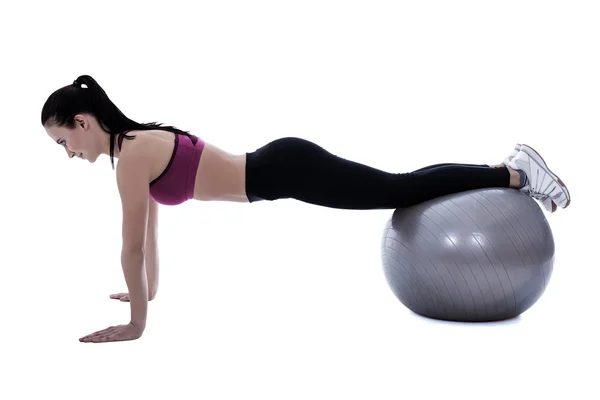 Silueta de mujer delgada en ropa deportiva haciendo push ejercicios — Foto de Stock