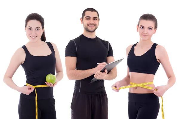 Belas mulheres desportivos slim com fita métrica e treinador ou morrer — Fotografia de Stock