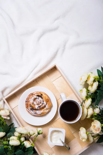 Good morning - breakfast with bun and tea on wooden tray and flo — Stock Photo, Image