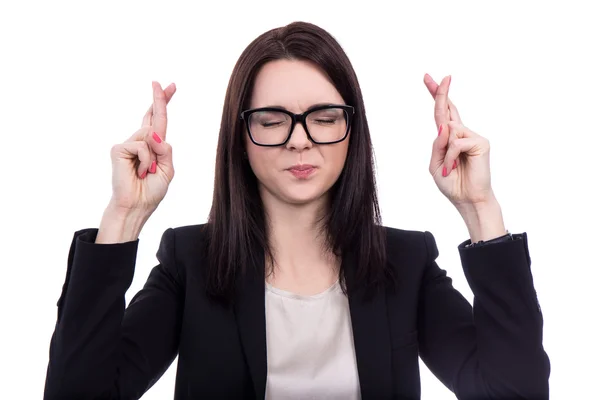 Hopeful business woman holding fingers crossed isolated on white — Stock Photo, Image