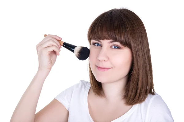 Portrait of young beautiful woman applying make up with brush is — Stock Photo, Image