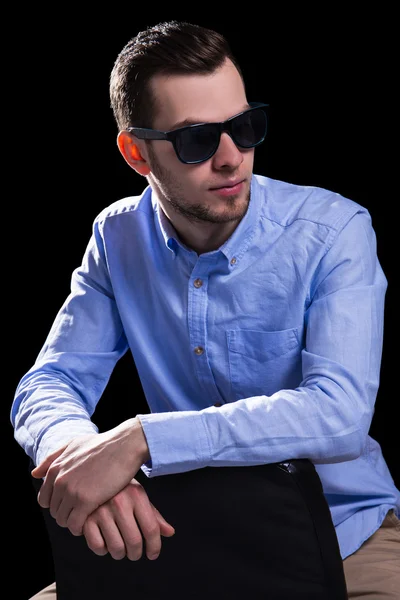 Young handsome man in sunglasses over black — Stock Photo, Image