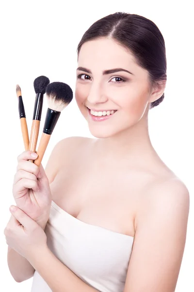 Portrait of young beautiful woman with make up brushes isolated — Stock Photo, Image