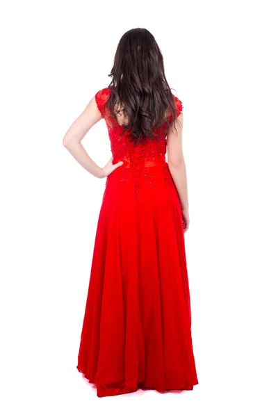Вид ззаду на молоду красиву жінку в червоній сукні ізольовано на білому — стокове фото