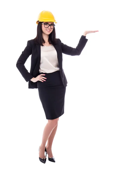 Business woman architect in yellow helmet presenting something i — Stock Photo, Image