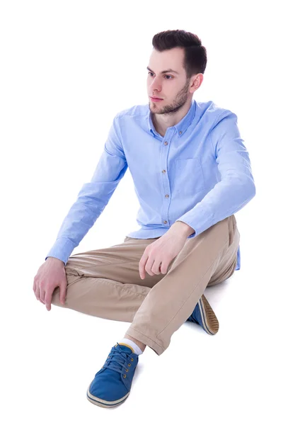 Ritratto dell'uomo triste che si siede isolato su bianco — Foto Stock