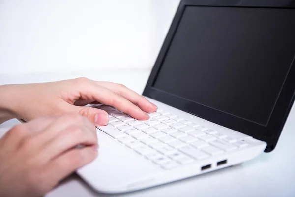 Woman using laptop and writing on keyboard — Stock Photo, Image