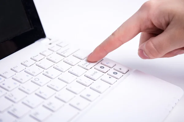 Female hand pushing enter button on laptop keyboard — Stock Photo, Image