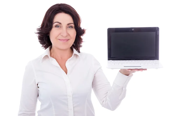 Beautiful mature business woman holding laptop with blank screen — Stock Photo, Image