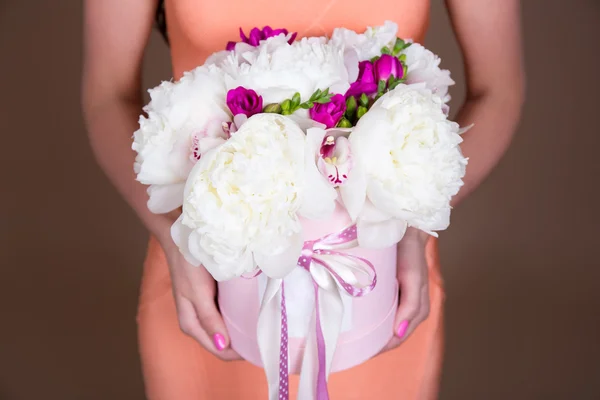 Boîte à fleurs de pivoine en mains féminines — Photo