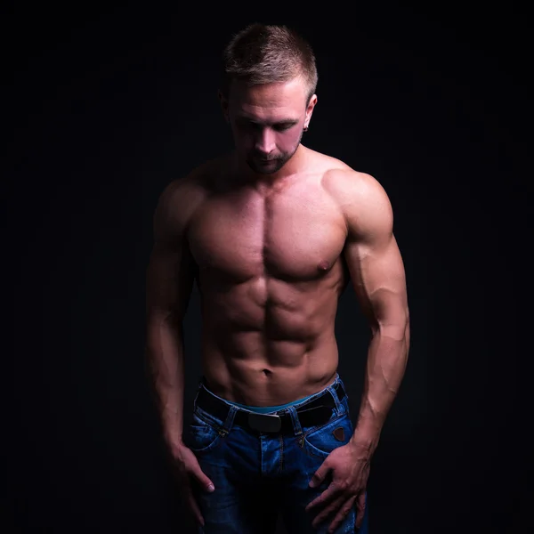 Sport concept - handsome muscular man posing over dark backgroun — Stock Photo, Image