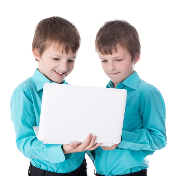 Two little boys twins using laptop isolated on white — Stock Photo, Image