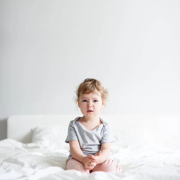 Displeased Cute Little Girl Sitting Bed Home Copy Space White — Stock Photo, Image