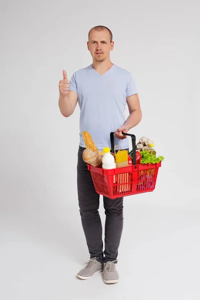 Full Length Portrait Young Man Shopping Basket Full Products Thumbs — Stock Photo, Image