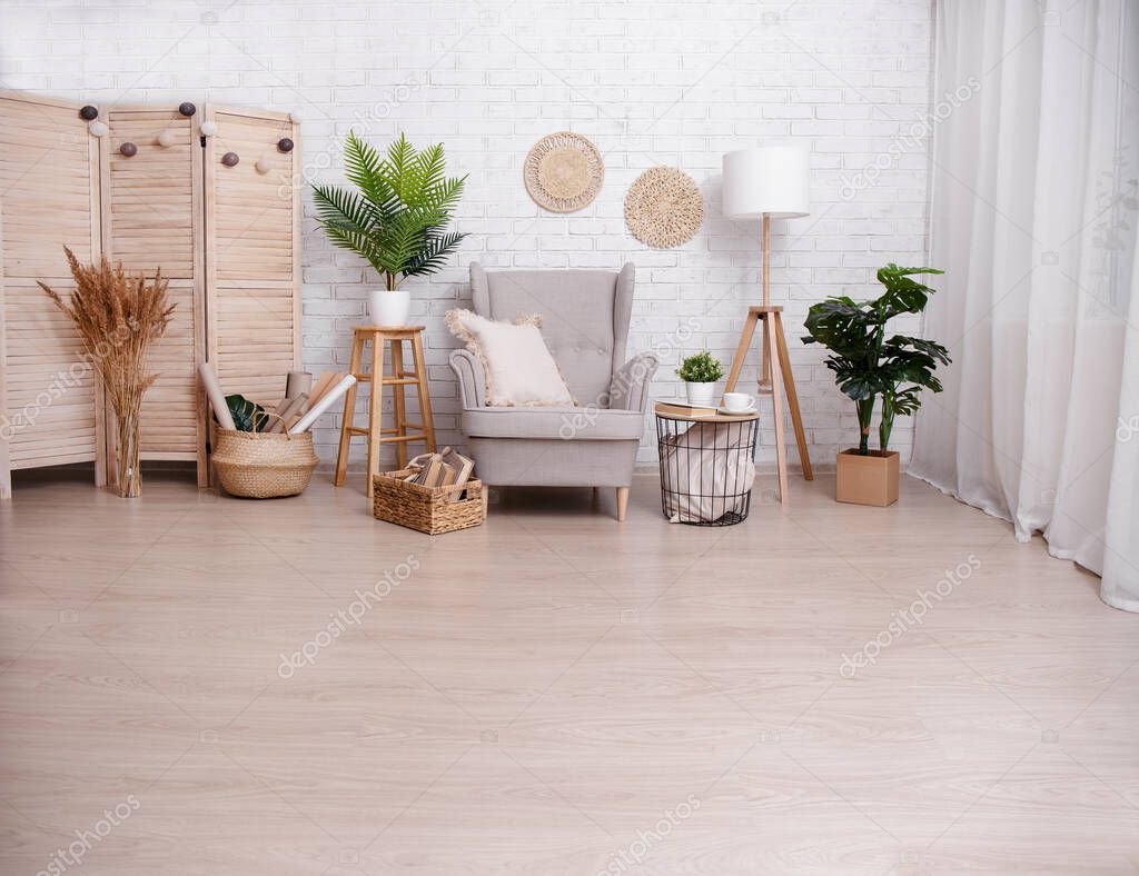 Room with armchair, lamp and plants over brick wall background with copy space