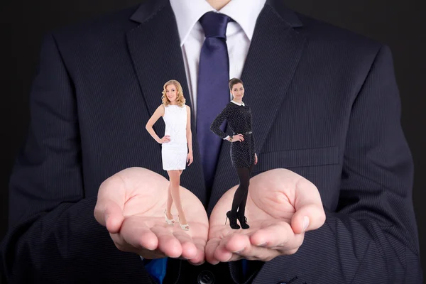 Business concept - man holding two women in his hands — Stock Photo, Image