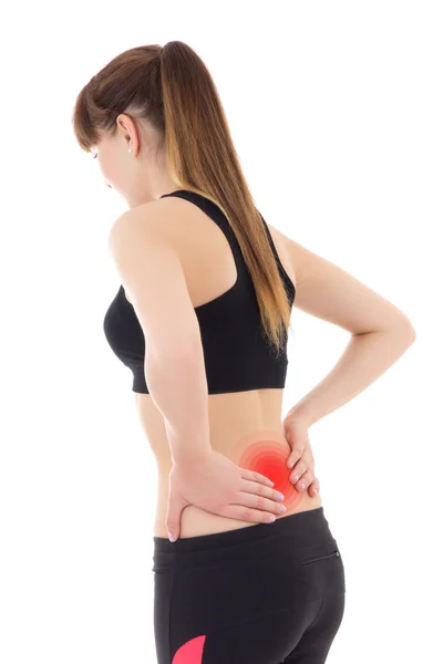 Girl in sportswear with pain in her back isolated on white — Stok Foto