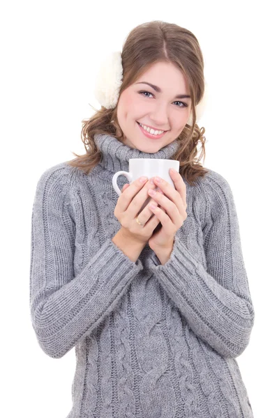 Happy attractive woman in woolen sweater and muffs holding cup o Stock Photo